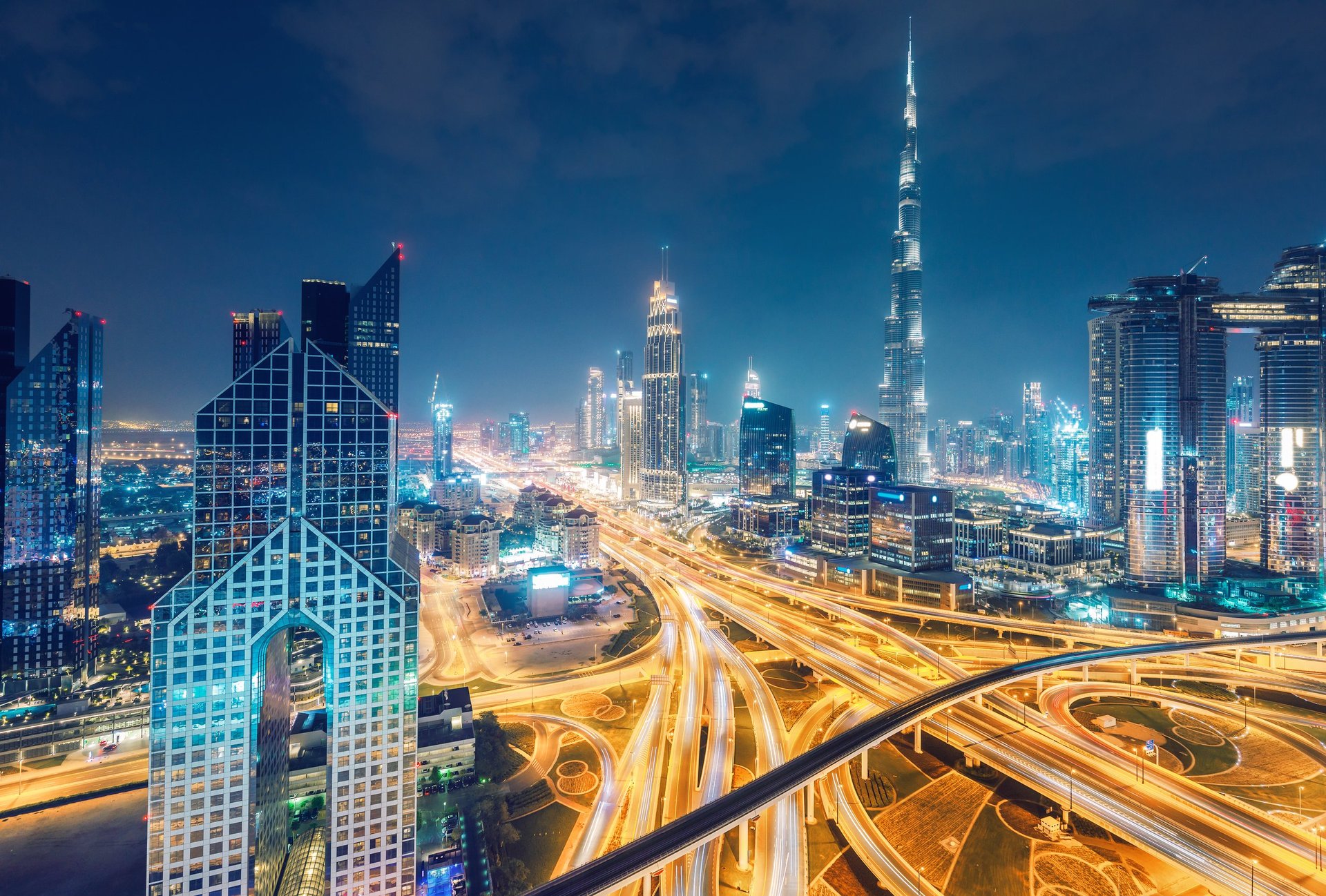 Downtown Dubai at night. Scenic aerial view on highways and skyscrapers.