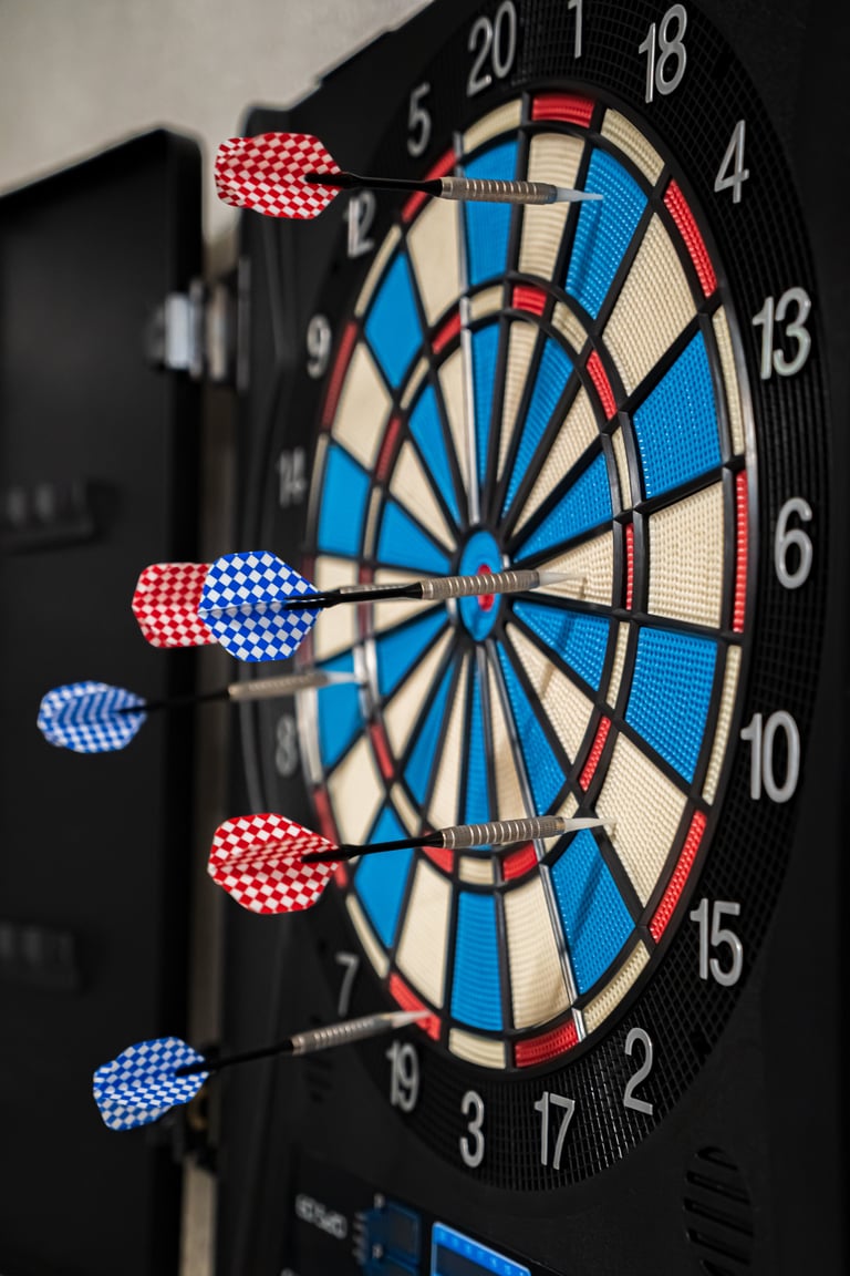 Blue and red darts on a dartboard