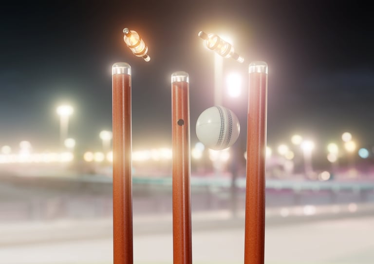 Cricket ball striking illuminated wickets at night