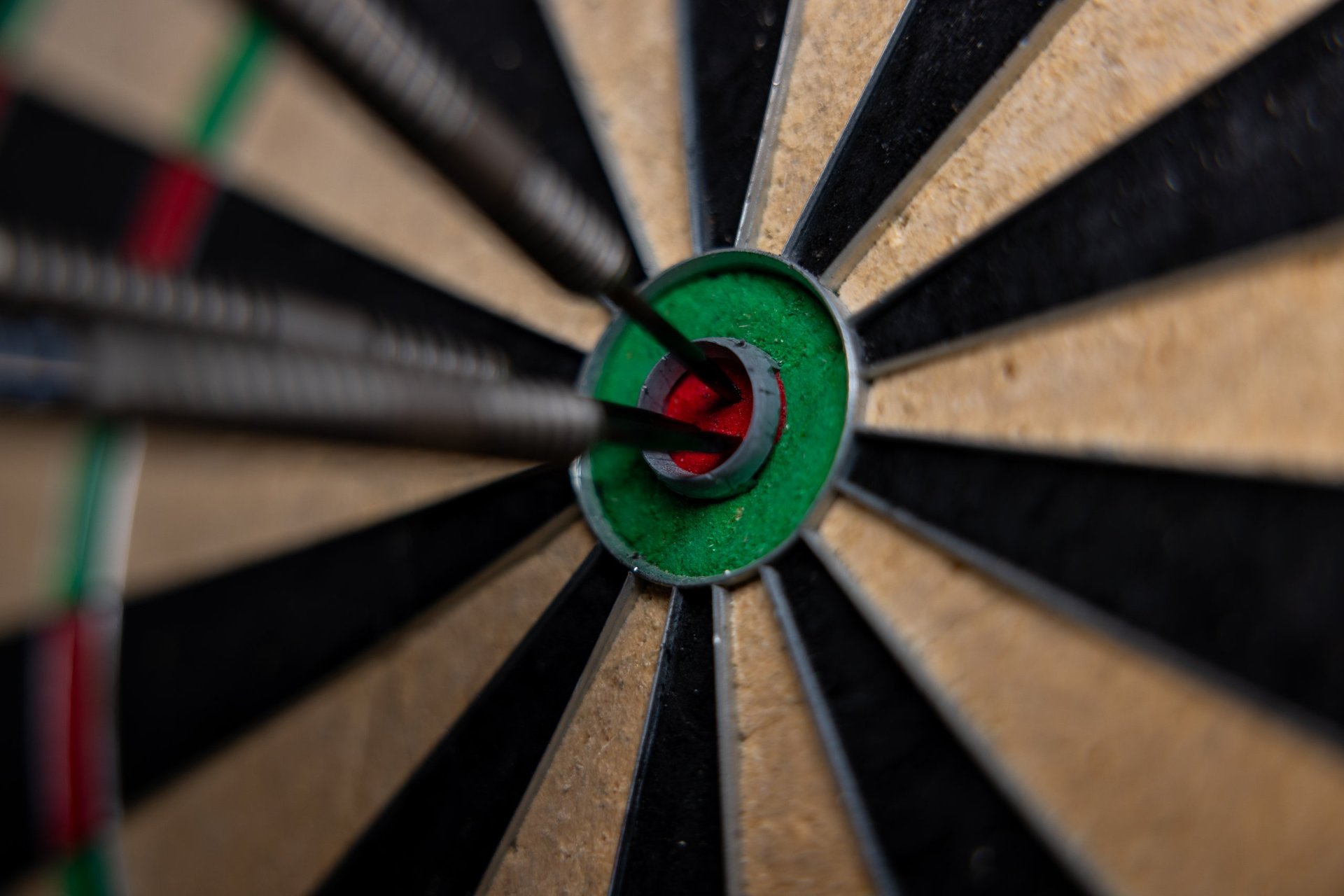 Darts arrows in the bull's eye close up