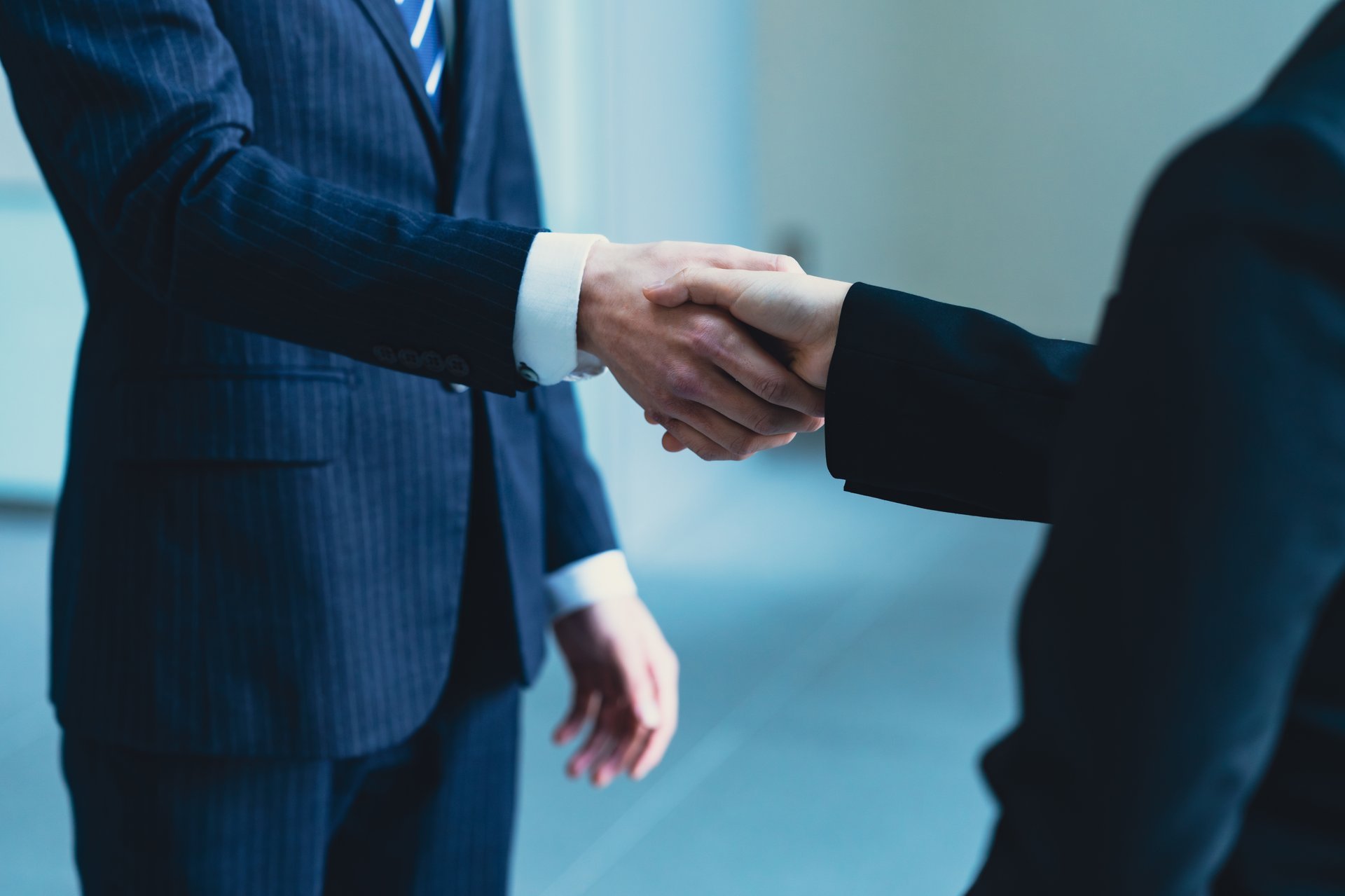 Two businessmen shaking hands after reaching an agreement