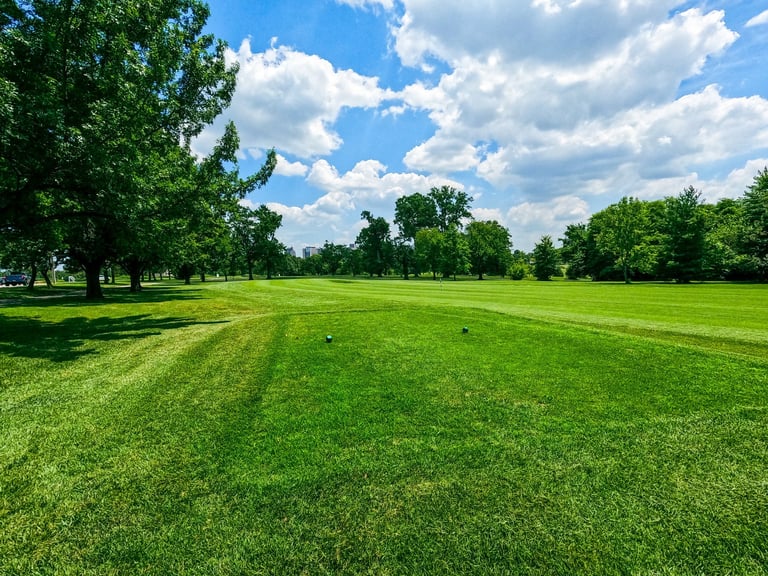 Open green fairway under blue skies