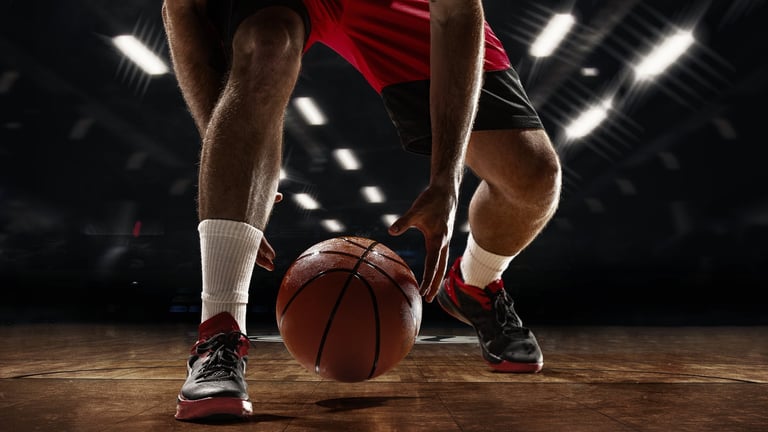 Basketball player dribbling on a hardwood court
