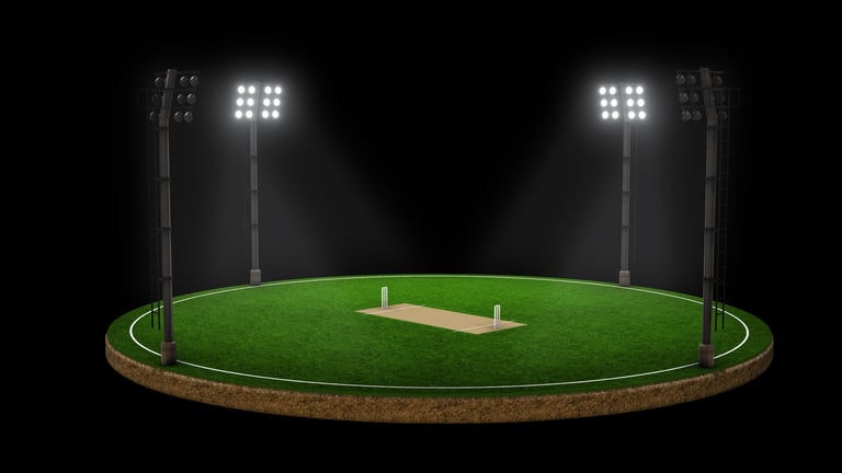 Floodlit cricket stadium at night