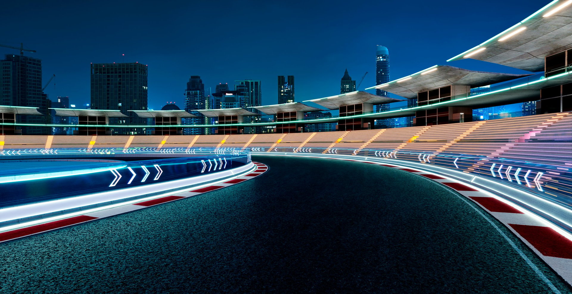 Floodlit racing circuit with grandstands at night